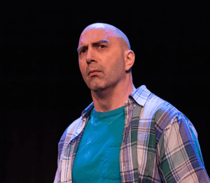 A bald man in a plaid shirt.