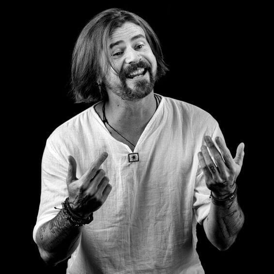 A black and white photo depicting a man with long hair and beard.